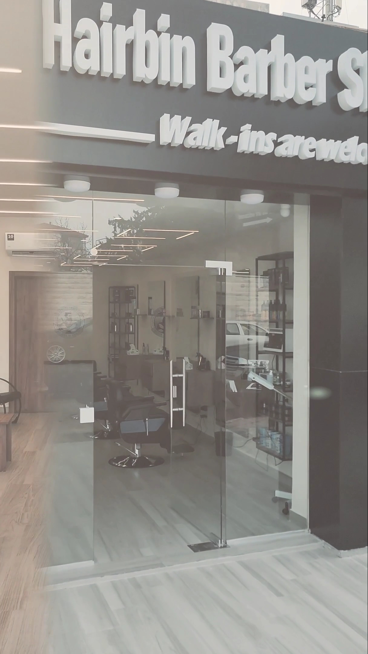 The Hairbin Barber Shop entrance at dusk